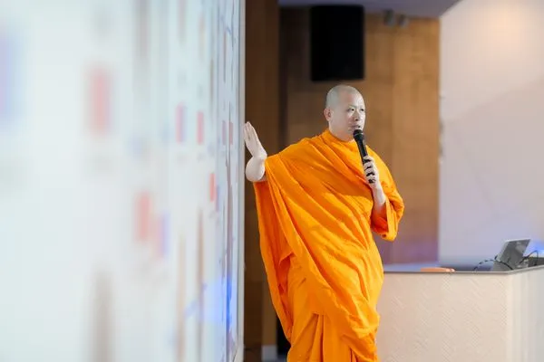 Stepping out from the lectern to explain a point