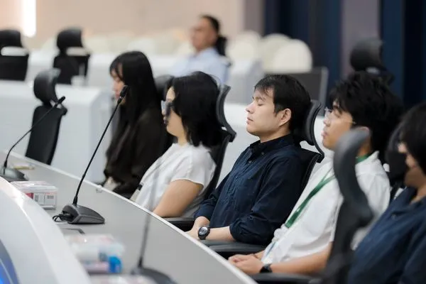 Participants listening from the tiered seats