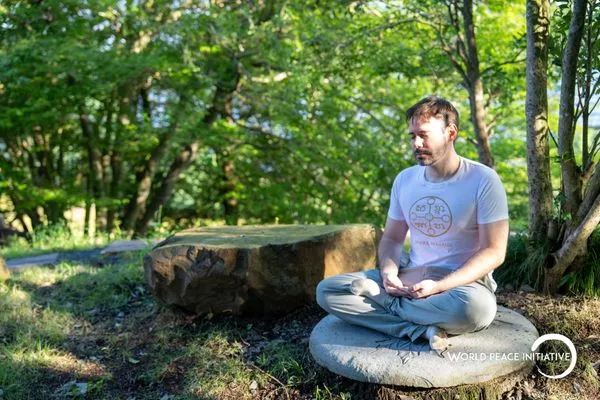 Meditating on a stone seat in the forest