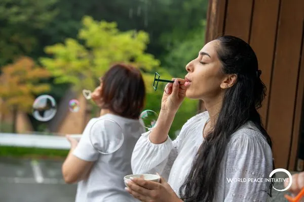 A pause between sessions, blowing bubbles on the veranda